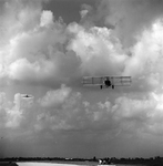 Biplane and Commercial Airplane in Flight Over Runway, Tampa, Florida, E by George Skip Gandy IV