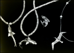 Two Shark Necklaces, a Shark Ring, and a Bird Necklace, B by Skip Gandy