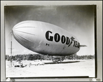 Goodyear Blimp Anchored in a Field