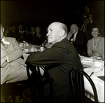 Man Sitting at Banquet Table