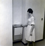 Exchange National Bank Woman Using Water Fountain, A by George Skip Gandy IV