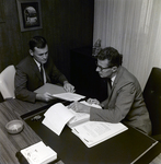 Exchange National Bank Ad Men Sitting at Desk with Documents, Tampa, A by George Skip Gandy IV
