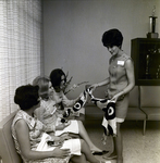 Exchange National Bank Woman Presenting Scarf at Bridal Luncheon, Tampa by George Skip Gandy IV