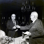 Two Men Exchanging a Pin, Exchange National Bank by George Skip Gandy IV