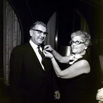 Exchange National Bank Woman Pinning Lapen Pin onto Man, Tampa by George Skip Gandy IV