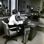 Jean Eason and Super Fred at Desk, Exchange National Bank by George Skip Gandy IV