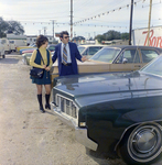 Man and Woman View Lincoln Continental at Lot, Exchange National Bank by George Skip Gandy IV