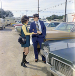 Man and Woman View Lincoln Continental at Lot, Exchange National Bank by George Skip Gandy IV