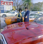 Man and Woman View Pontiac at Lot, Exchange National Bank by George Skip Gandy IV