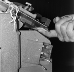 Person Inspecting a Metal Equipment, B by George Skip Gandy IV