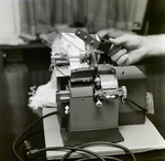 Person Inspecting a Dennison Dial Set Printer, B by George Skip Gandy IV