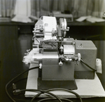 Person Inspecting a Dennison Dial Set Printer, D by George Skip Gandy IV