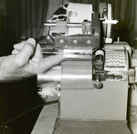 Person Inspecting a Dennison Dial Set Printer, E by George Skip Gandy IV