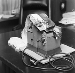 Person Inspecting the Parts of a Dennison Dial Set Printer, F by George Skip Gandy IV