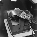 Person Inspecting the Parts of a Dennison Dial Set Printer, M by George Skip Gandy IV