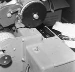 Person Inspecting the Parts of a Dennison Dial Set Printer, N by George Skip Gandy IV