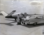 Technician and Couple Standing by Plane by George Skip Gandy IV