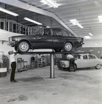 Technician Works under Volvo on Lift at Kennedy Strickland Motor Company, B by George Skip Gandy IV