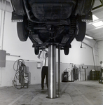Technician Works under Volvo on Lift at Kennedy Strickland Motor Company, C by George Skip Gandy IV