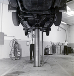 Technician Works under Volvo on Lift at Kennedy Strickland Motor Company, D by George Skip Gandy IV