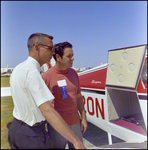 Two Men Looking at a Plane at Aviation Expo by Skip Gandy