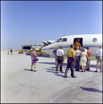 People in Front of a Plane at Aviation Expo, A by Skip Gandy