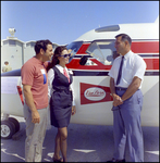 Three People Talking in Front of a Plane at Aviation Expo by Skip Gandy
