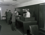 People at Counter at Tampa Marine Bank by George Skip Gandy IV