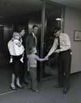 Security Guard Shaking Young Boy's Hand at Tampa Marine Bank by George Skip Gandy IV