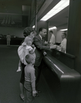 Family at Teller Window at Tampa Marine Bank by George Skip Gandy IV