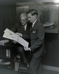 Men Looking at Newspaper in Tampa Marine Bank by George Skip Gandy IV