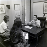People Sitting at Desk at Walker & McLane in Tampa, A by George Skip Gandy IV