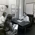 People Sitting at Desk at Walker & McLane in Tampa, B by George Skip Gandy IV