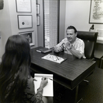 People Sitting at Desk at Walker & McLane in Tampa, C by George Skip Gandy IV