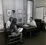 People Sitting at Desk at Walker & McLane in Tampa, E by George Skip Gandy IV