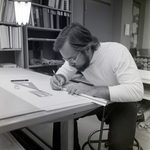 Man Working at Desk at Walker & McLane in Tampa, B by George Skip Gandy IV