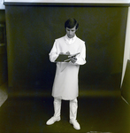 Man in X-Ray Apron Holding Clipboard and Ruler for Medico Int., A by George Skip Gandy IV