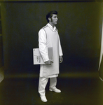 Man in X-Ray Apron Holding Film for Medico Int., N by George Skip Gandy IV