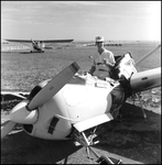 Man Sitting in Crashed Plane by Skip Gandy