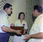 Three People Holding Bottle in Box, Misener Industries, B by George Skip Gandy IV