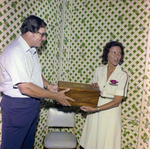 Two People Holding Bottle in Box, Misener Industries, B by George Skip Gandy IV