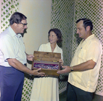 Three People Holding Bottle in Box, Misener Industries, D by George Skip Gandy IV