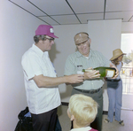 Man Pouring Champagne at DC-530 Launch, Misener Industries, A by George Skip Gandy IV