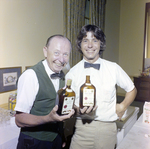 Two Attendees Holding Bacardi Bottles at Misener Industries Event by George Skip Gandy IV