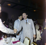 Mario Belaval and Attendee Shaking Hands at Misener Industries Event by George Skip Gandy IV