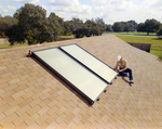 Employee Installing Solar Panel on Roof, C by George Skip Gandy IV