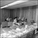 Man and Woman at Desk in Anderson Surgical Supply Company Office Space, A by Skip Gandy