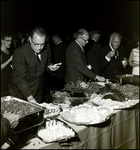 Men Getting Food at a Banquet Table by Skip Gandy