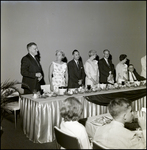 Group of Well Dress Standing by a Banquet Table, B by Skip Gandy