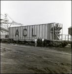 Men Stand in Front of ACL 500000 Freight Train Car, A by Skip Gandy